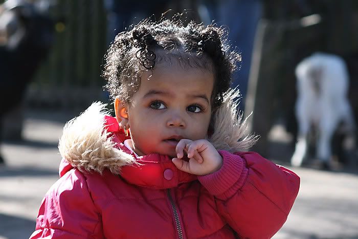 girl in sunlight and pink coat