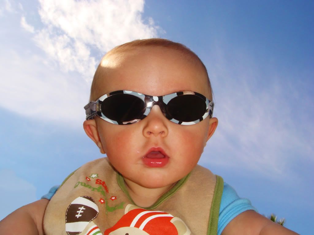 baby boy in sunglasses with blue sky