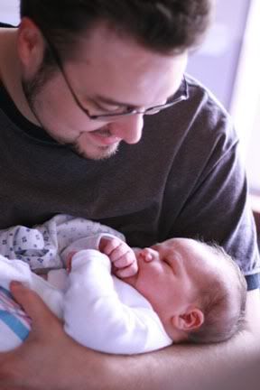 father holding newborn in hospital