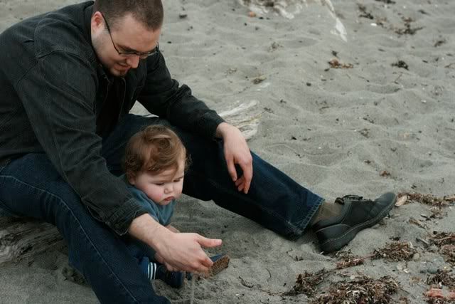 dad playing in the sand with baby