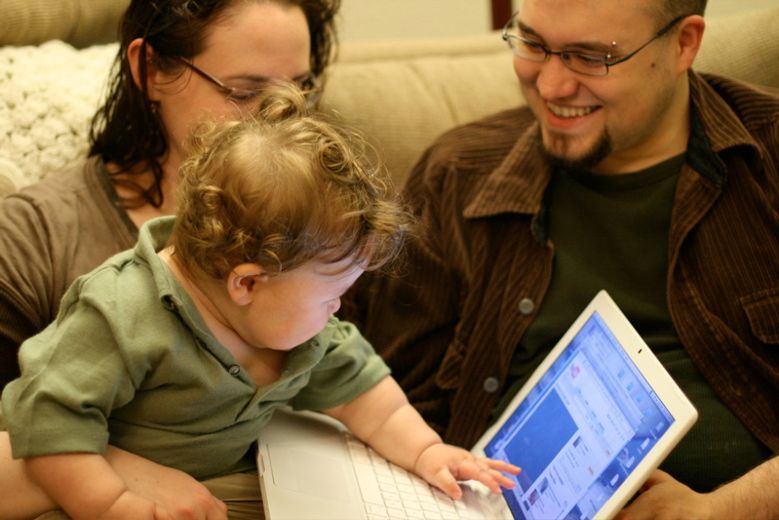 boy baby looking at videos of himself on computer