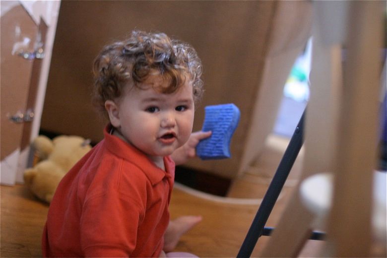 Photo Credit: Hobo Mama toddler holds sponge — cleaning baby