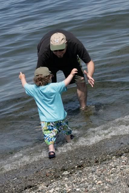 toddler running to dad's arms in ocean
