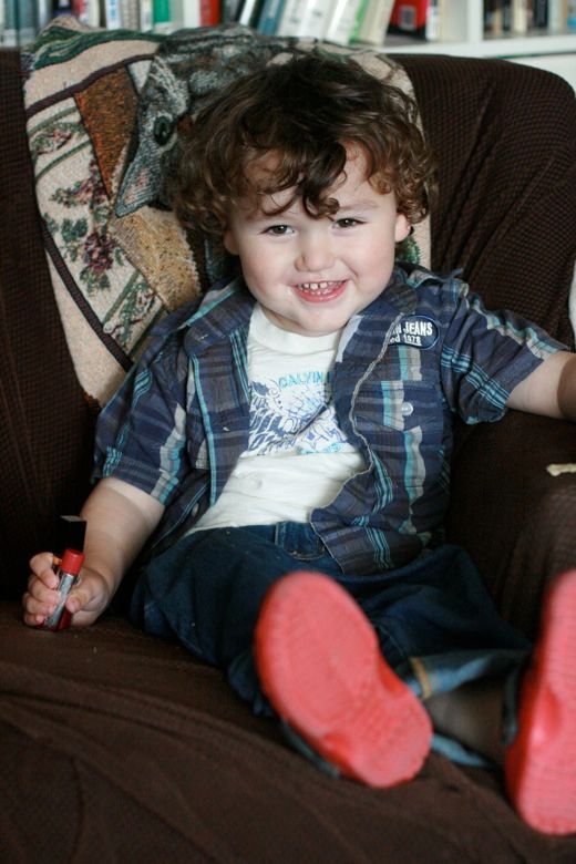 cute preschool boy in a brown chair