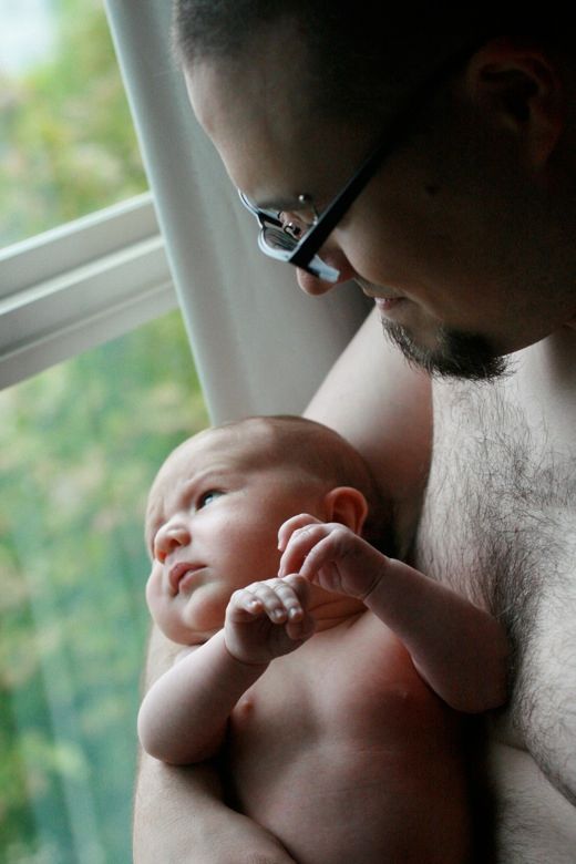father and newborn baby son Alrik 4 weeks old in window