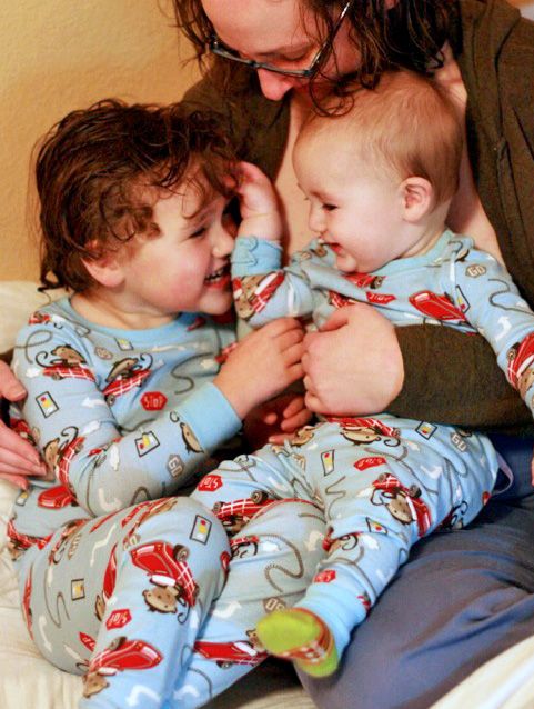 mother snuggling boys in matching jammies