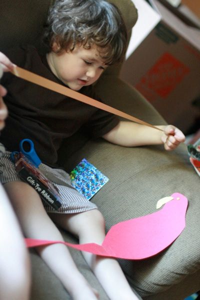 3 pulling out ribbon for the tail feathers — pirate parrot craft mikko m4yo
