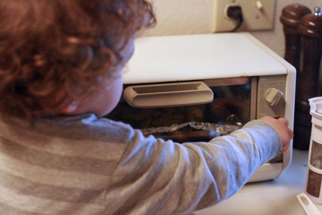toddler making fries - 6 pushing toast button