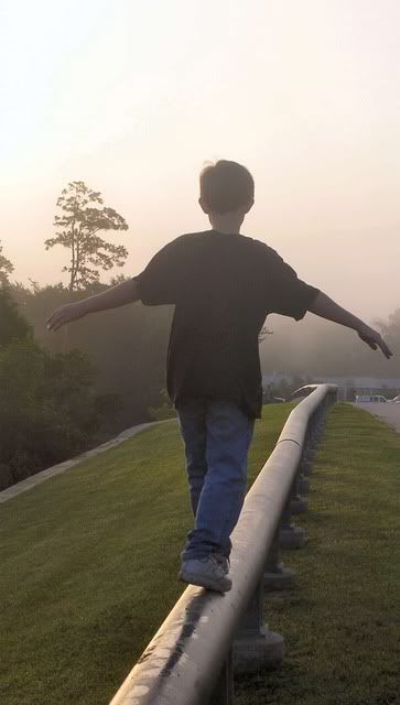 boy balancing along beam