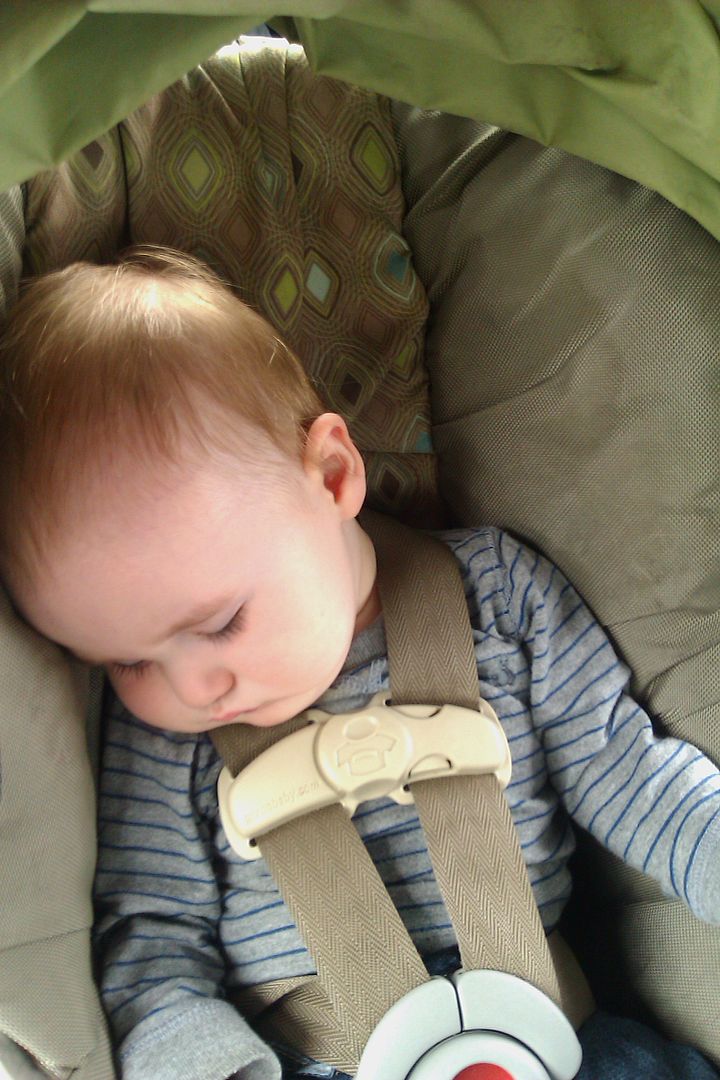 baby asleep in his car seat rear-facing
