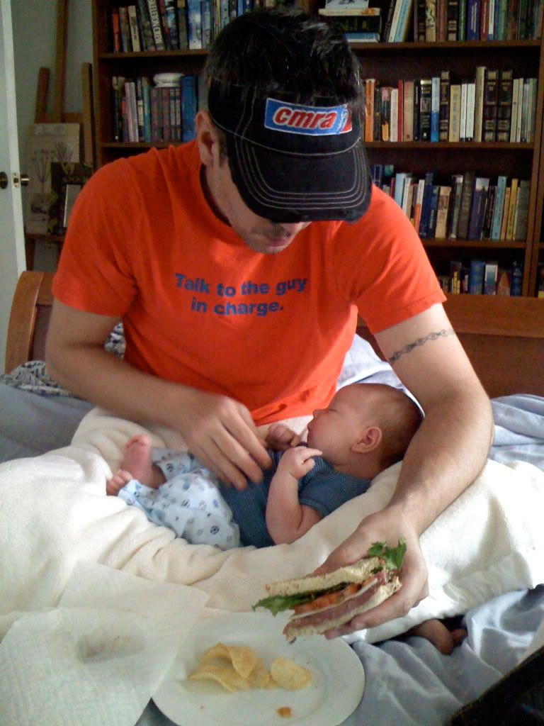 father eating over newborn baby