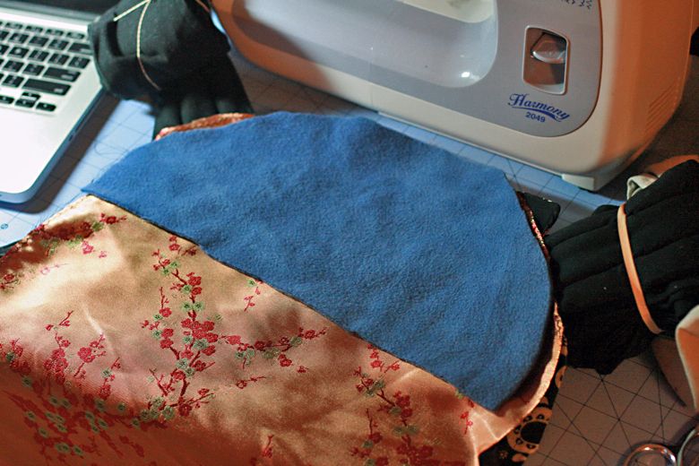 Photo Credit: Hobo Mama adding padding for panel — black mei tai tutorial