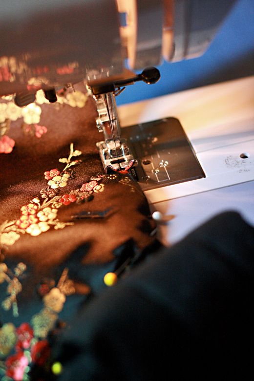 Photo Credit: Hobo Mama sewing together with machine — black mei tai tutorial