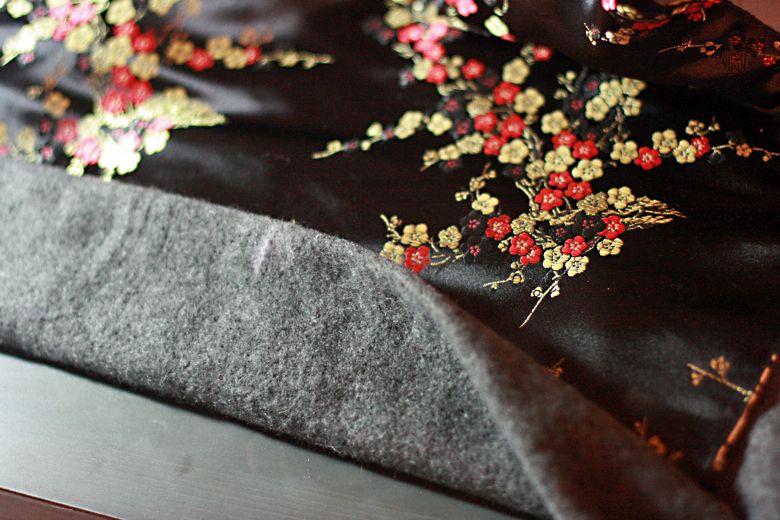 Photo Credit: Hobo Mama adding padding to waist — black mei tai tutorial