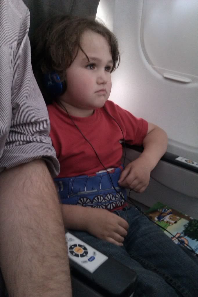 young boy sitting on airplane