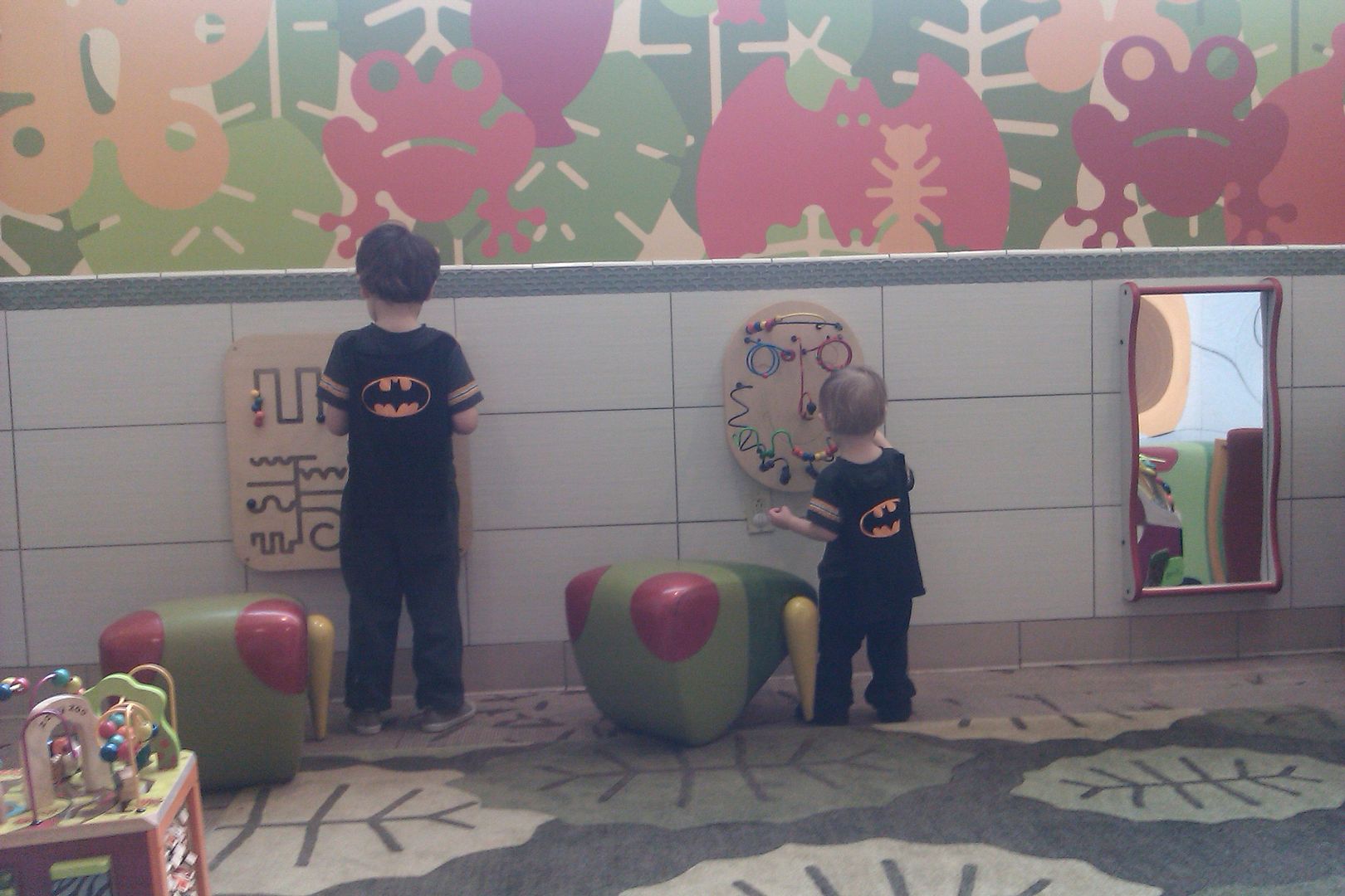 Sunday Surf: Babywearing Batman == Hobo Mama two boys playing in mall play area