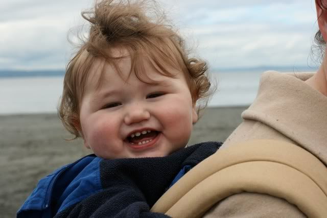 baby in Ergo carrier on mom's back on beach