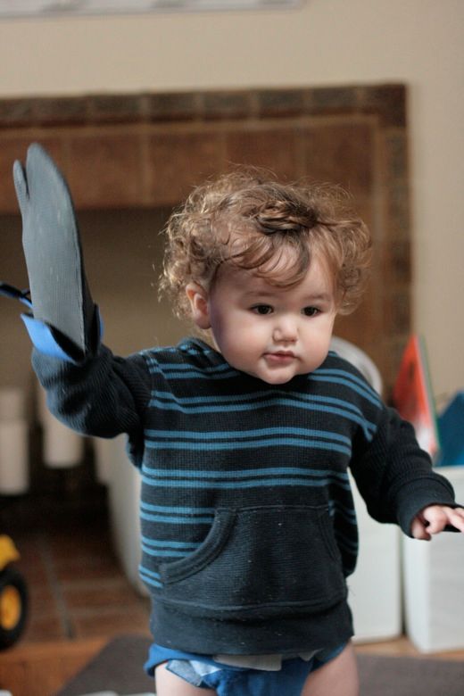 toddler wearing oven mitts