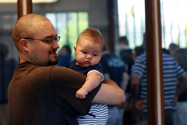 baby in church cry room separated from congregation by glass wall