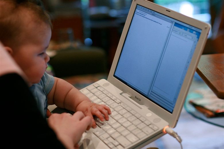 Baby typing on a laptop computer