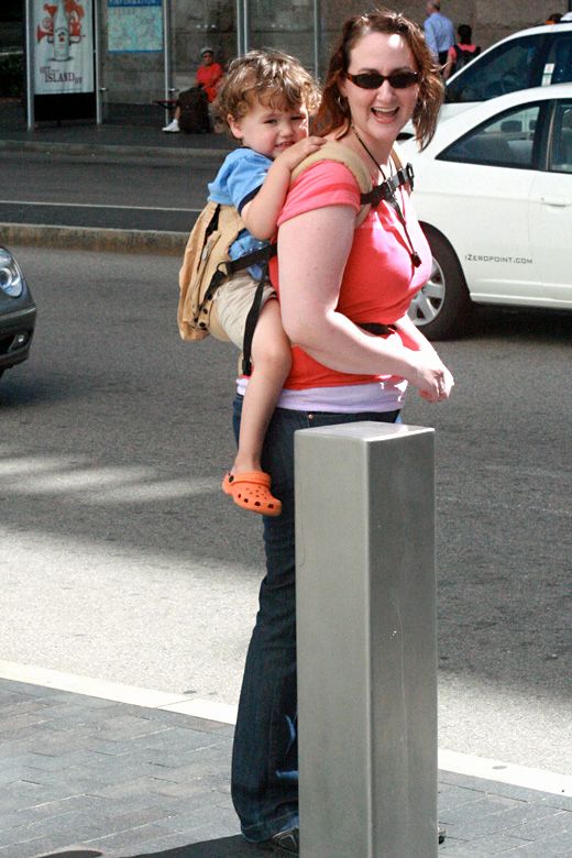 babywearing a preschooler in Boston next to bollard