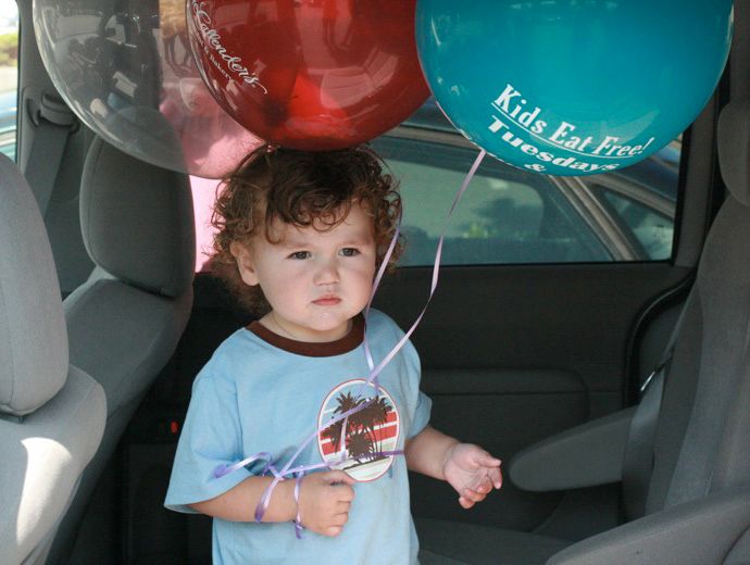 Boy with three balloons
