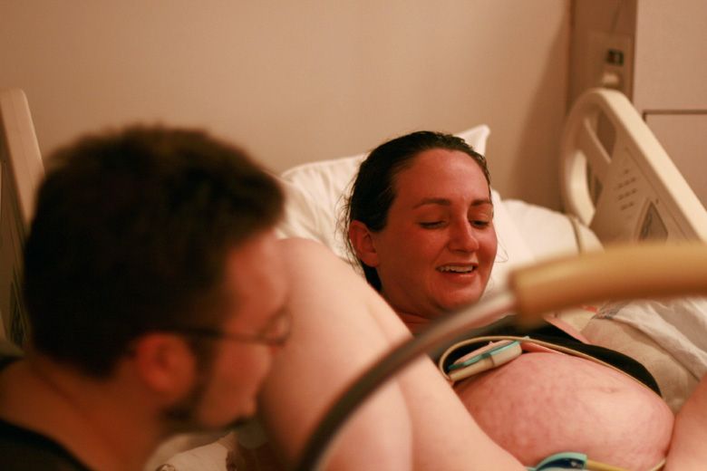 birth — smiling because it's time to push during labor at hospital