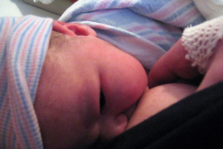 birth — breastfeed newborn baby up close