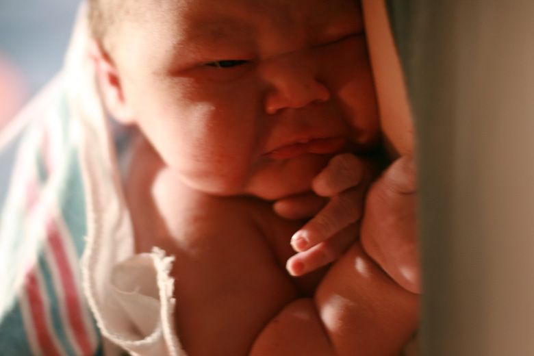 birth — newborn baby pouting