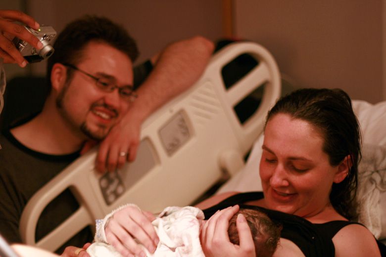 birth — happy family with newborn