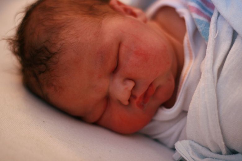 birth — all wrapped up swaddled newborn baby in hospital