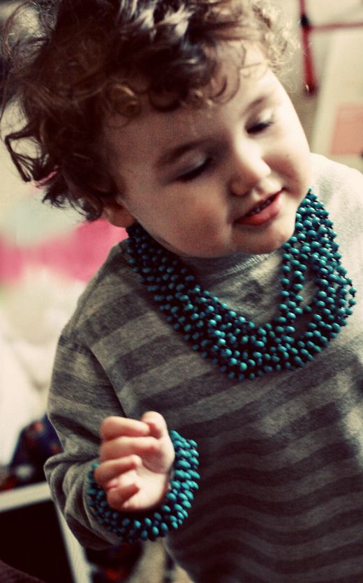 boy wearing turquoise bead necklace and bracelet