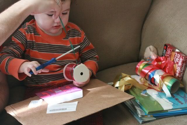 toddler cutting ribbon for collage