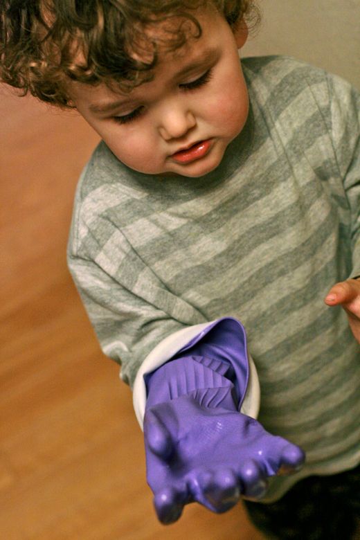 Photo Credit: Hobo Mama toddler with large purple dish glove — cleaning baby