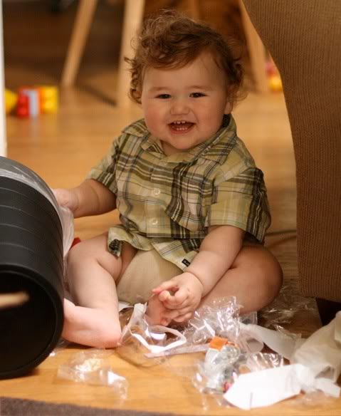 baby emptying trash can
