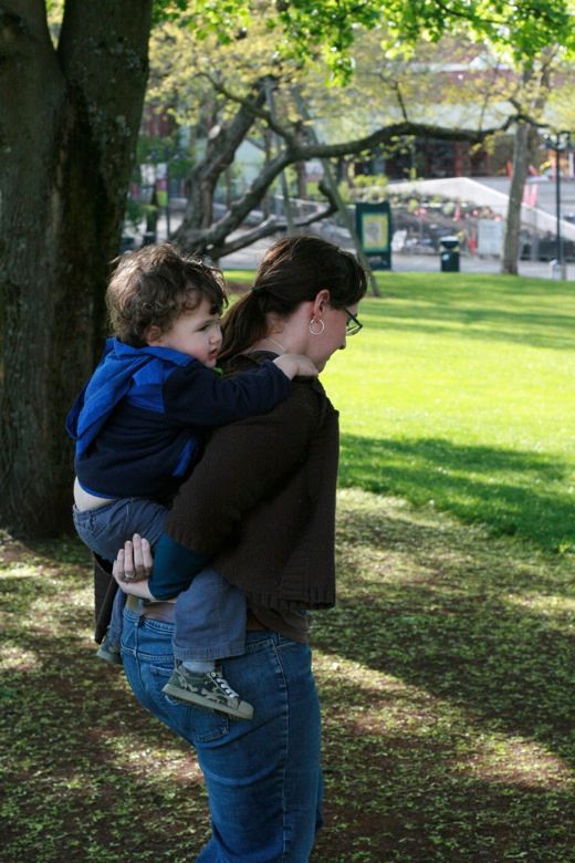 Mama piggyback carrying toddler on back