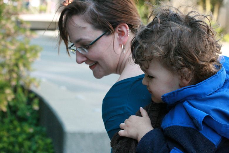 Mama and preschooler gazing into fountain