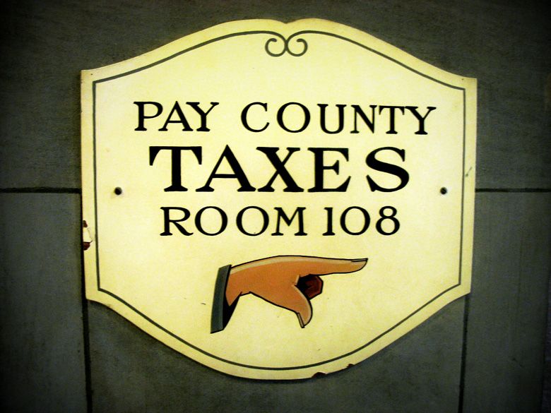pay county taxes sign with arrow