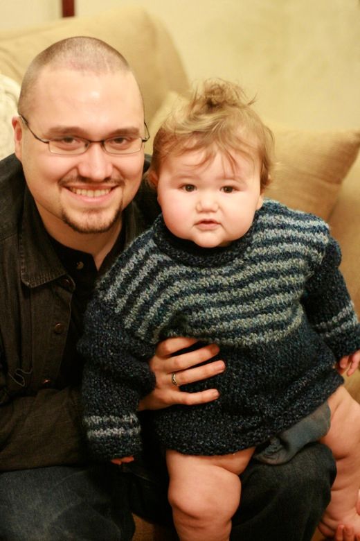 knitted sweater on baby with father