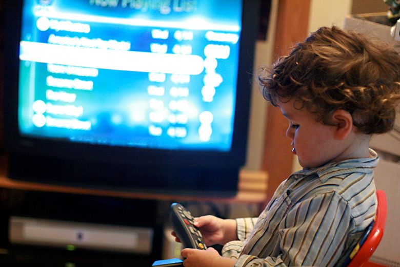 boy working Tivo remote control