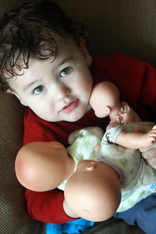 toddler holding dolls