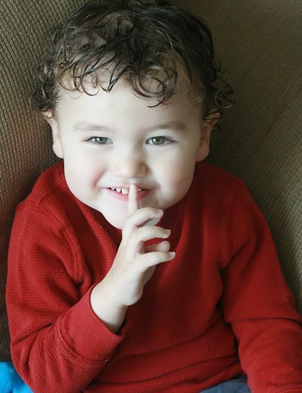 toddler with finger to lips