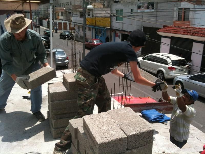 Moving materials from the truck to the roof.