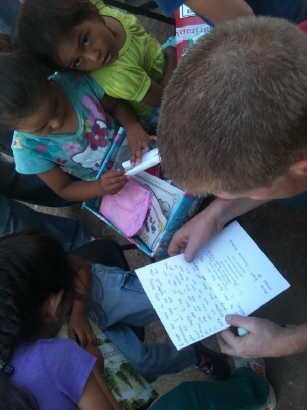 Doug reading a letter that one little girl received from a little girl in Missouri.