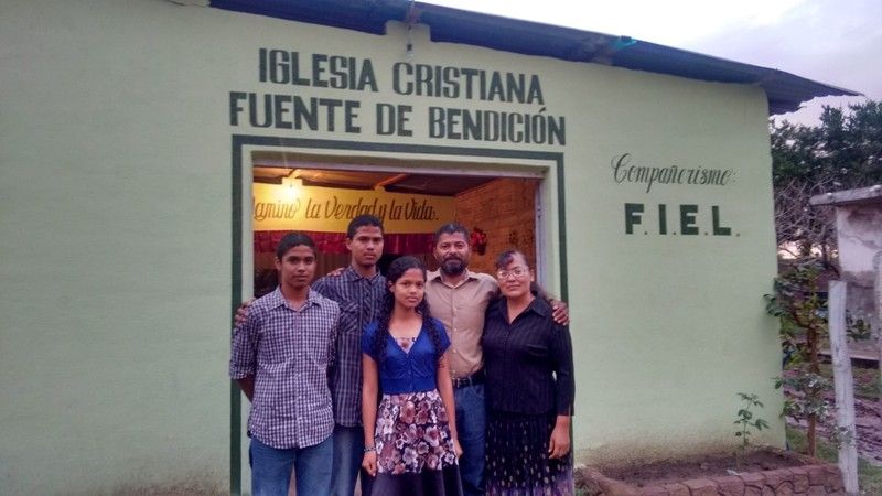 Narciso and Maria with their kids, Samuel, Jonathan and Catherine in front of the church building in Quimichis.