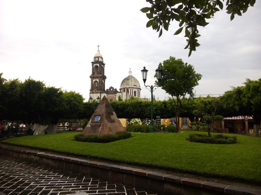 City park and Catholic church on the square in Tarimoro