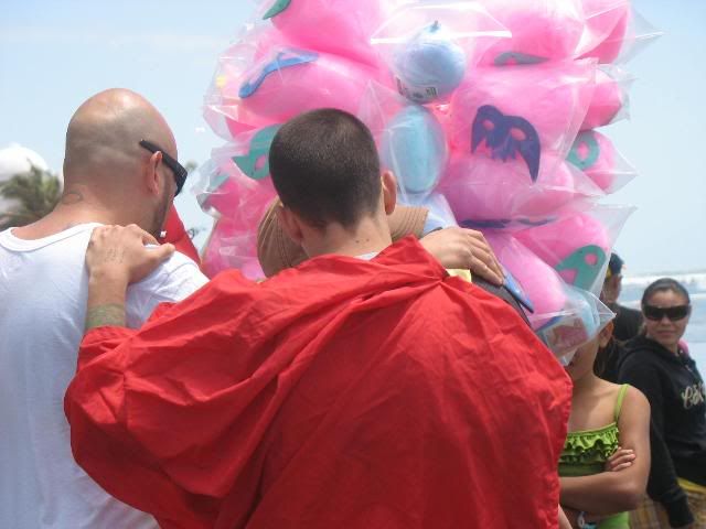 Members of the team pray with a man selling cotton candy after one performance.