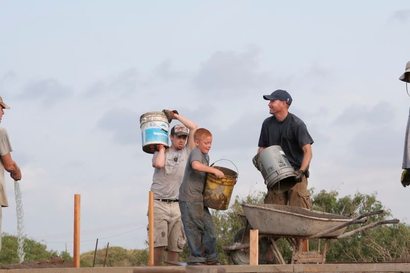 Step 2: Begin hauling buckets of concrete up the hill