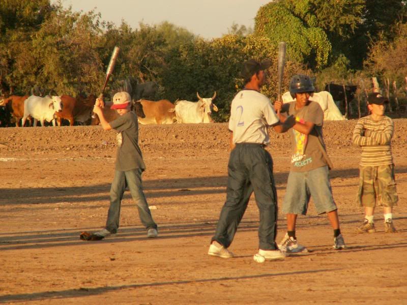 Jessee prepares to bat while Andrew looks on